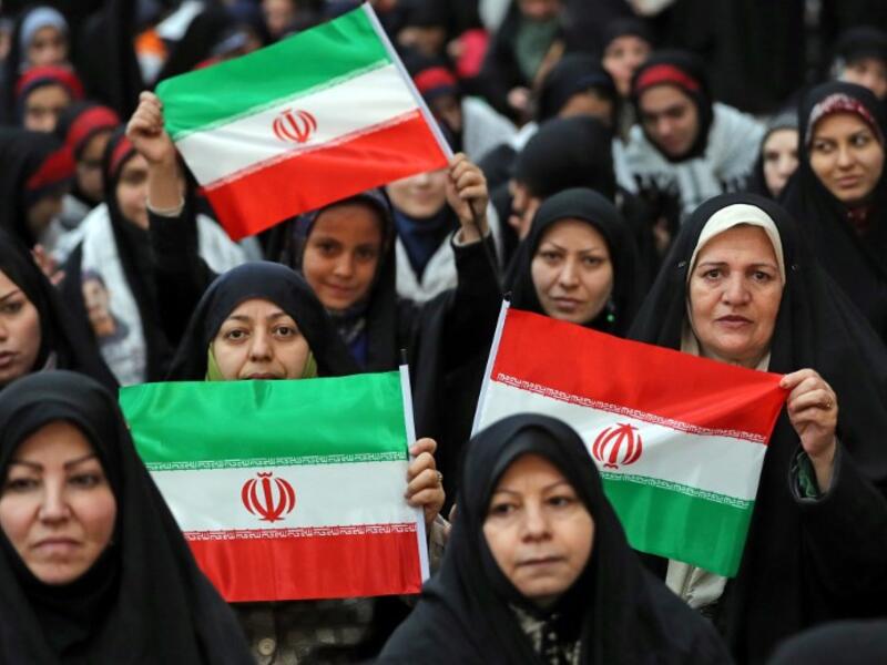 An Iranian woman holds a poster of Iran's late founder of the Islamic Republic, Ayatollah Ruhollah Khomeini
STR / AFP