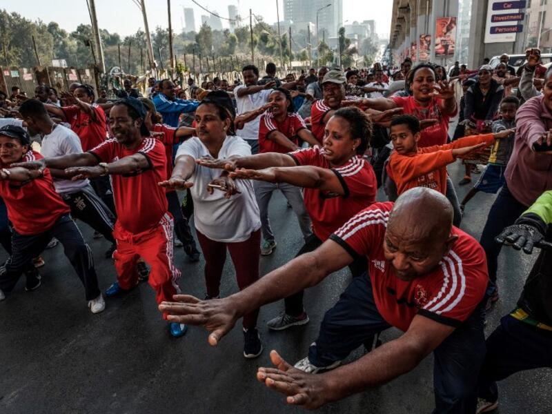 People take part in an exercise on a street in Addis Ababa on February 3, 2019 during the third Car Free Day promoted by local NGOs and the Ethiopian Government to appeal to a healthy life style and a less air pollution of the capital city. 
EDUARDO SOTERAS / AFP