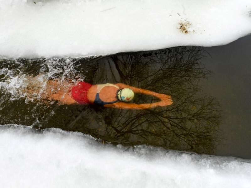 Natalya Seraya, the founder and chief of Moscow's ice swimming club "Walruses of the Capital", swims in a strip of water cut in the ice by the bank of the Moscow River on February 3, 2019. 
Kirill KUDRYAVTSEV / AFP