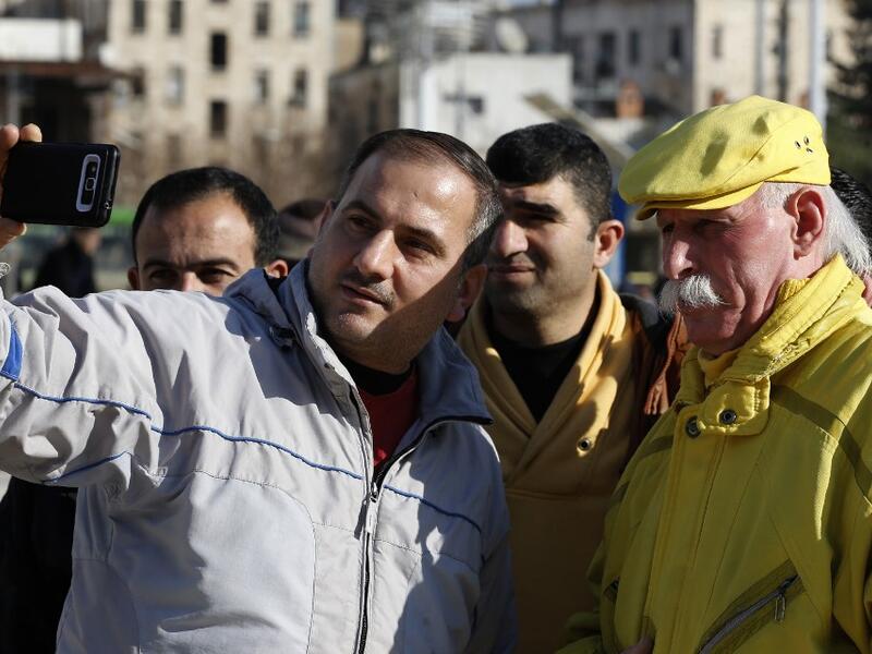 Abu Zakkour, Aleppo's so-called 'yellow man' poses for a selfie photograph in the central Saadallah al-Jabiri square in the northern Syrian city on February 11, 2019. 
LOUAI BESHARA / AFP