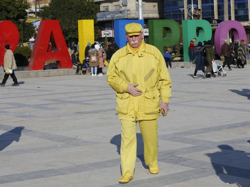 Abu Zakkour, Aleppo's so-called 'yellow man' walks in the central Saadallah al-Jabiri square in the northern Syrian city on February 11, 2019.
LOUAI BESHARA / AFP