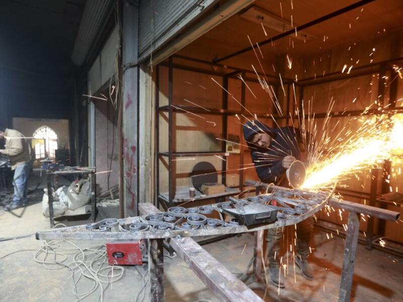 Labourers take part in restoration work at the Saqatiya market in the old quarter of Syria's second city of Aleppo
LOUAI BESHARA / AFP