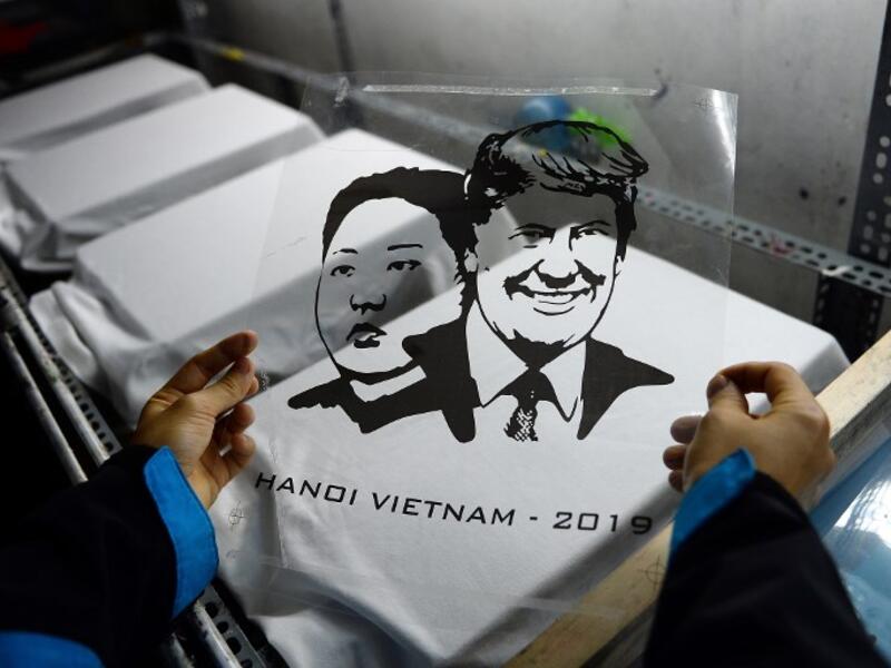 A Vietnamese worker prepares to print T-shirts with portraits of US President Donald Trump and North Korean leader Kim Jong Un at a workshop in Hanoi on February 22, 2019, ahead of the ahead of the second Trump and Kim summit. 
Nhac NGUYEN / AFP