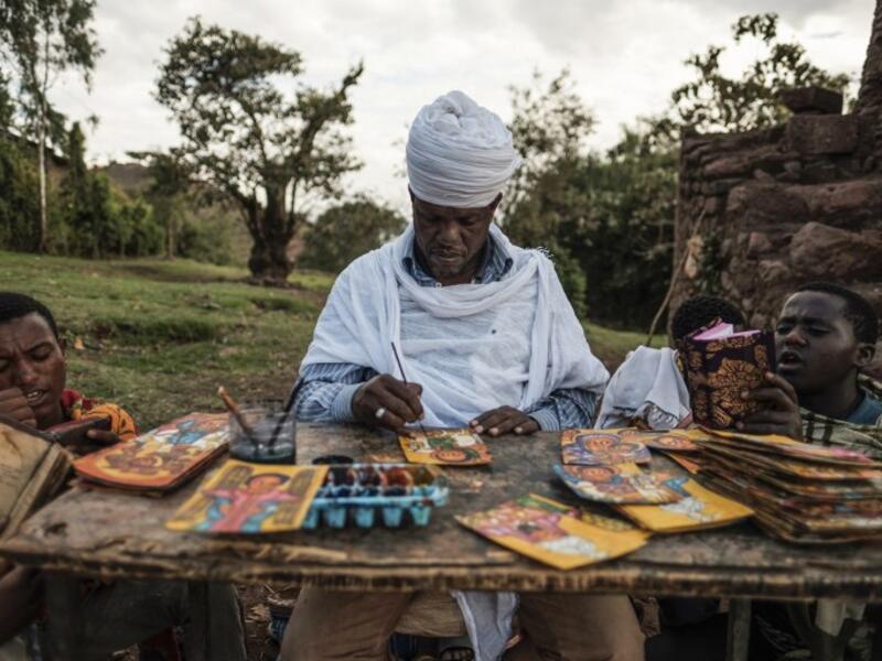 An Ethiopian Orthodox artist paints postcards in Lalibela, Ethiopia
EDUARDO SOTERAS / AFP