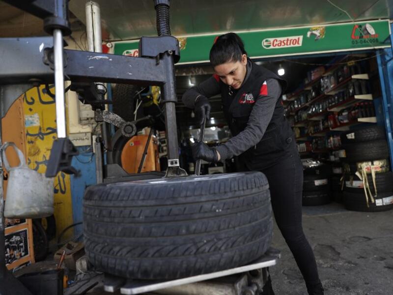 Amina repairs a flat tyre at a car tyre's repair shop in Beirut on March 8, 2019. Amina has been working for 10 years in mechanics, specially in the tyres repair business. She considers it fulfilling as she always dreamt of doing that job.
JOSEPH EID / AFP