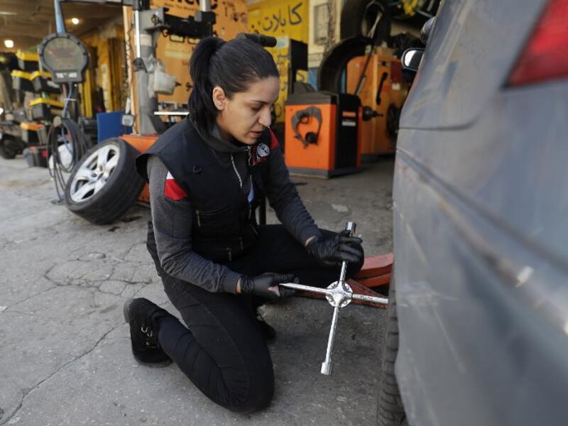 Amina repairs a flat tyre at a car tyre's repair shop in Beirut on March 8, 2019. Amina has been working for 10 years in mechanics, specially in the tyres repair business. She considers it fulfilling as she always dreamt of doing that job.
JOSEPH EID / AFP