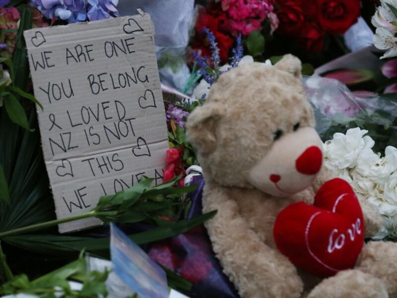 A note is seen beside floral tributes at a makeshift memorial for victims of the March 15 mosque attacks, in Christchurch 
DAVID MOIR / AFP