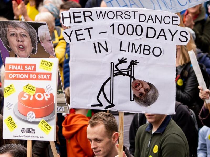 People hold up placards as they attend a march and rally organised by the pro-European People's Vote campaign for a second referendum in central London on March 23, 2019. 
Niklas HALLE'N / AFP