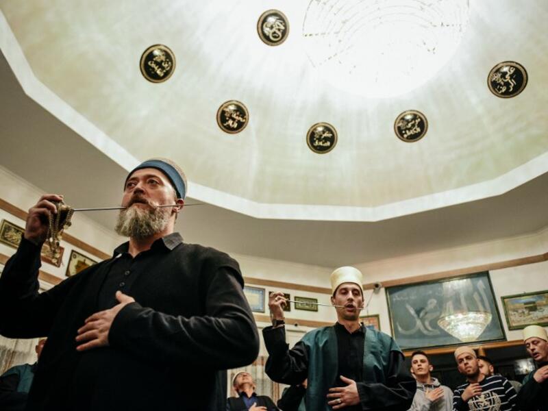 Kosovo Dervishes, adepts of Sufism, a mystical form of Islam, pierce their cheek with a needle during a ceremony in a prayer room in Gjakova
Gent SHKULLAKU / AFP