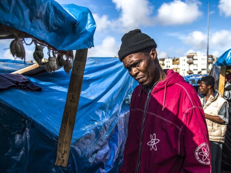 A sub-Saharan migrant walks between make-shift tents in the Oulad Ziane migrant camp in Casablanca on March 27, 2019. 
FADEL SENNA / AFP
