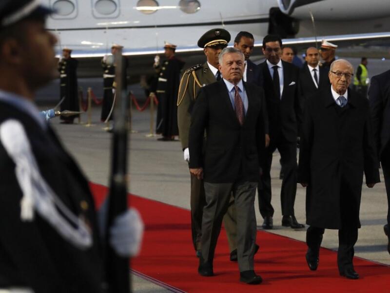 Tunisian President Beji Caid Essebsi (R) receives King Abdullah II of Jordan upon his arrival at Tunis-Carthage international airport on March 30, 2019, to attend the Arab Summit tomorrow. 
Hussein Malla / POOL / AFP
