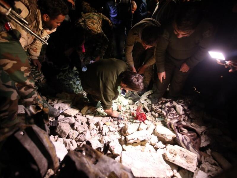 Syrian government security forces inspect the site of a series of attacks the area of the Sayyida Zeinab shrine south of Syria's capital Damascus on February 21, 2016. (AFP/Youssef Karwashan)
