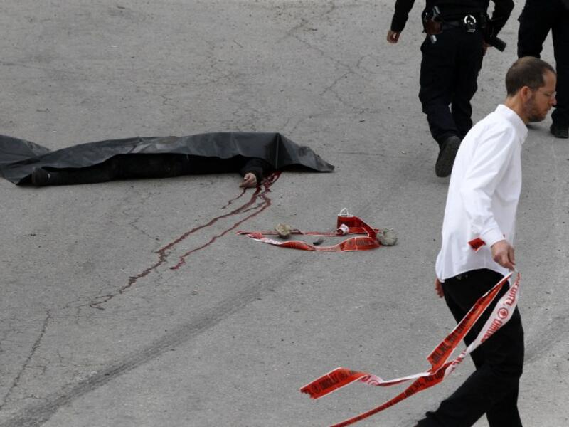 The body of a Palestinian assailant who was allegedly shot in the head by an Israeli soldier as he lay wounded on the ground Hebron on March 24, 2016. (AFP/Hazem Bader)