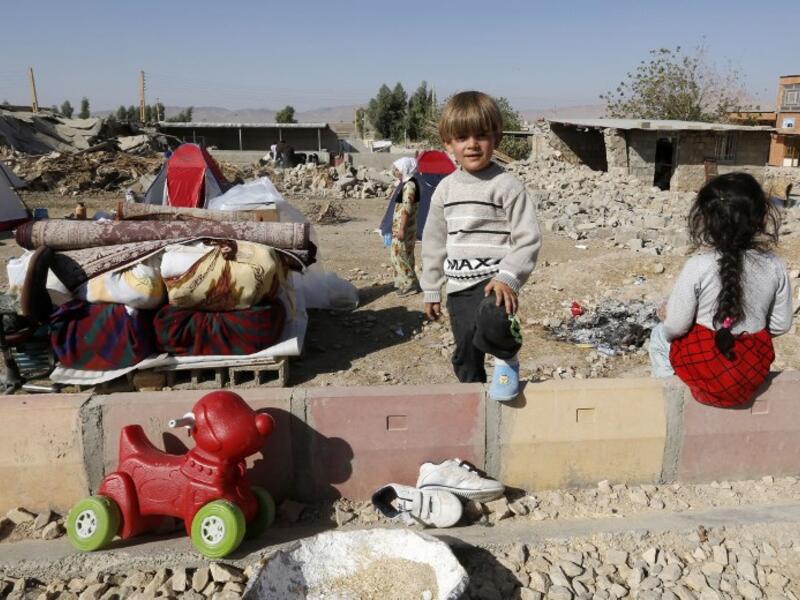 Iranian children next to the rubble of their home in Kouik village near to Sarpol-e Zahab.

(ATTA KENARE / AFP)