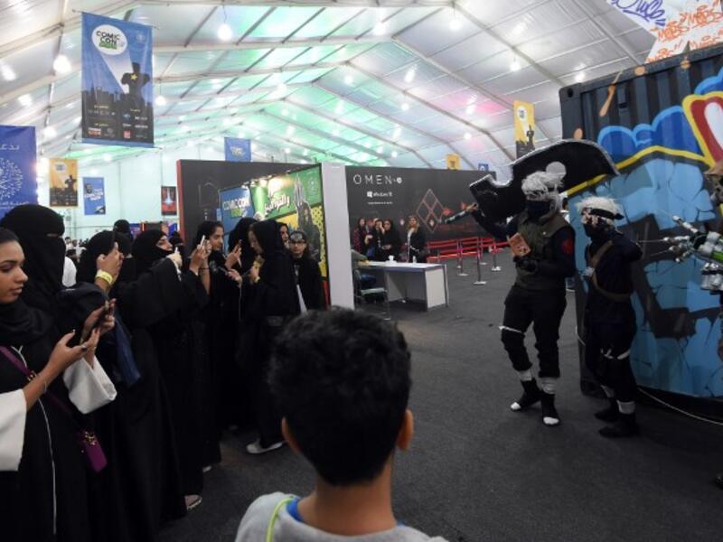 Saudi women uses their cell phones to take pictures of posing cosplayers during the first ever Comic-Con Arabia event held in the capital Riyadh on November 25, 2017. 
(FAYEZ NURELDINE / AFP)