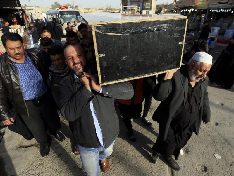 Iraqis carry the coffin of a victim during a funeral in the holy city of Najaf, on January 15, 2018, following today's twin suicide bombing in the capital Baghdad. Iraq's Prime Minister Haider al-Abadi called for the elimination of jihadist "sleeper cells" after the bombing killed 31 people in Baghdad in the second such attack in three days.