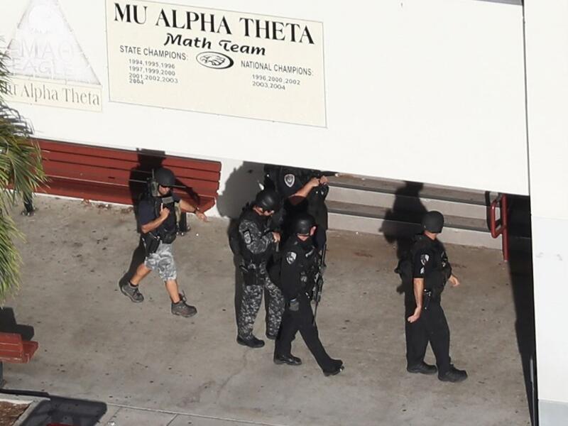 Law enforcement personel work the scene at the Marjory Stoneman Douglas High School after a shooting at the school that reportedly killed and injured multiple people on Feb. 14, 2018 in Parkland, Florida. Numerous law enforcement officials continue to investigate the scene. (Joe Raedle/Getty Images/AFP)