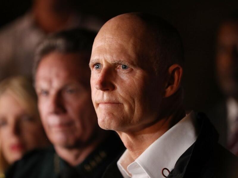 Florida Governor Rick Scott speaks to the media as he visits Marjory Stoneman Douglas High School after a shooting at the school killed 17 people on Feb. 14, 2018 in Parkland, Florida. Numerous law enforcement officials continue to investigate the scene. 
(Joe Raedle/Getty Images/AFP )