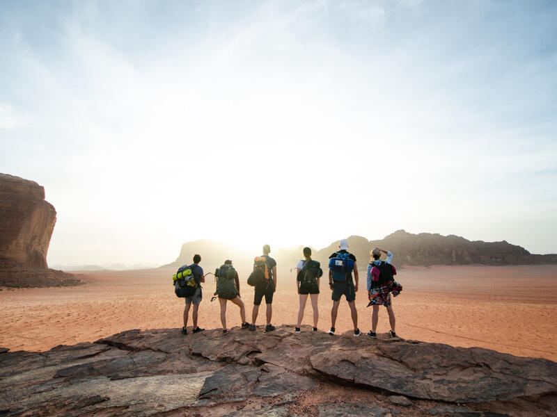 Tourist friends on a top of mountains in a desert. Sunset view. Nature. Tourist people enjoy a moment in a nature. Wadi rum national park - Jordan (Shutterstock/File Photo)