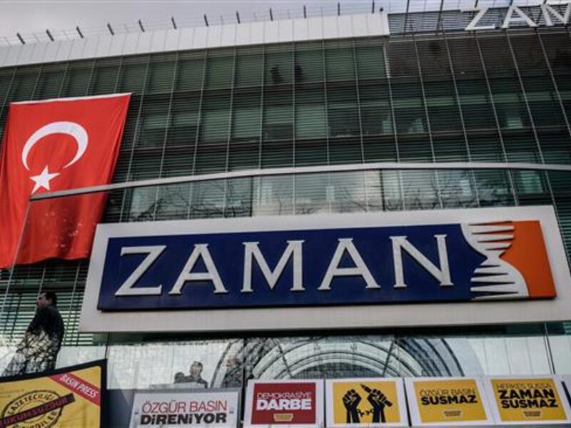 The logo of Turkish daily newspaper Zaman is seen on the headquarters building as people demonstrate in support of the newspaper in Istanbul on March 4, 2016. (AFP/File)