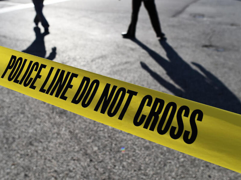 Police officers stand behind crime scene tape (AFP/File Photo)	