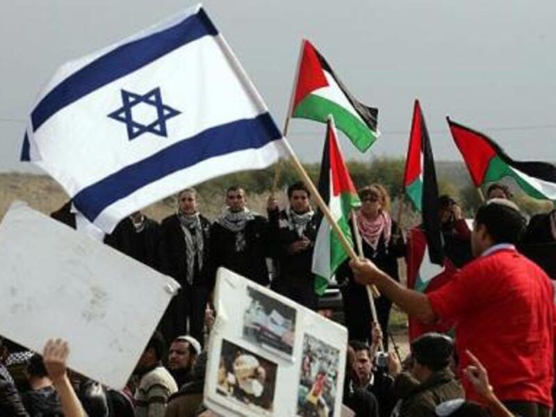 Israeli activist waves Israeli flag as Israeli Arabs wave Palestinian flag (AFP/File Photo)