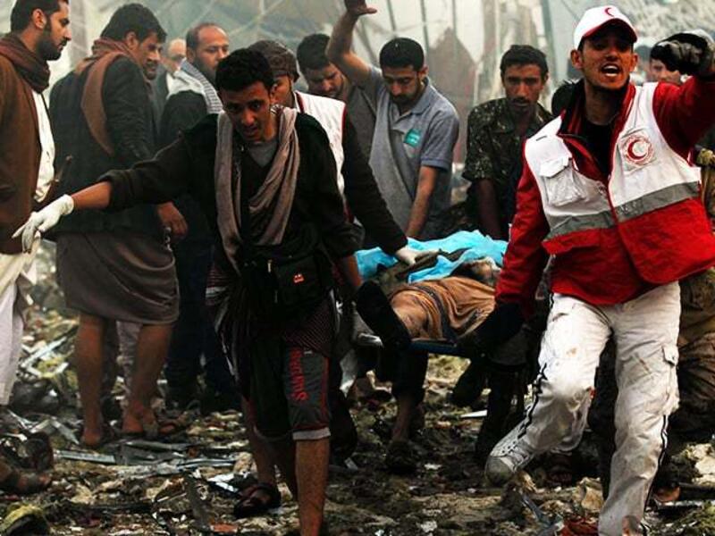 Yemeni rescue workers carry a victim on a stretcher amid the rubble of a destroyed building. (AFP/ File Photo)