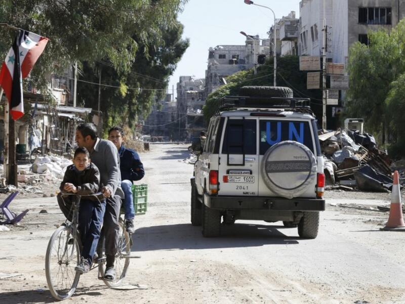 A vehicle of the UN agency for Palestinian refugees (UNRWA) drives through a street in Yarmuk camp southern Damascus on November 1, 2018. 
LOUAI BESHARA / AFP
