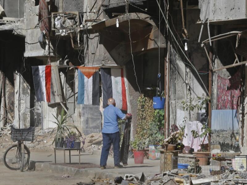 A man stands in a street near destroyed buildings in the Palestinian camp of Yarmuk southern Damascus on November 1, 2018. 
LOUAI BESHARA / AFP