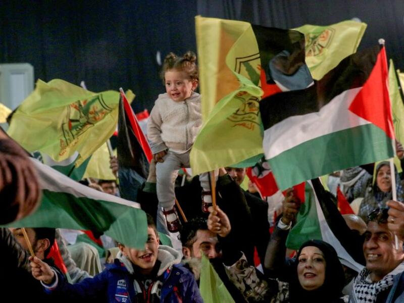 People wave flags of Palestine and Fatah as they attend a mass wedding ceremony for 150 Palestinian couples and 50 other Lebanese couples
Mahmoud ZAYYAT / AFP