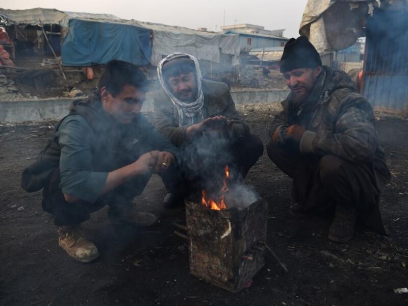 In this photograph, Afghan charcoal vendors warm up around a fire amid heavy smog conditions in Afghanistan's capital Kabul. 
WAKIL KOHSAR / AFP