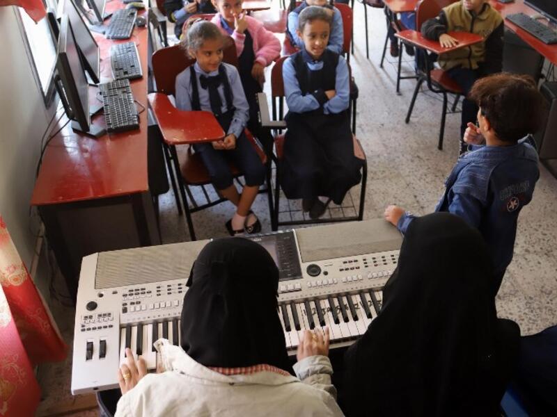 Children attend a music class at the Al-Nawras school in Taez, Yemen's third city, in the country's southwest
AHMAD AL-BASHA / AFP
