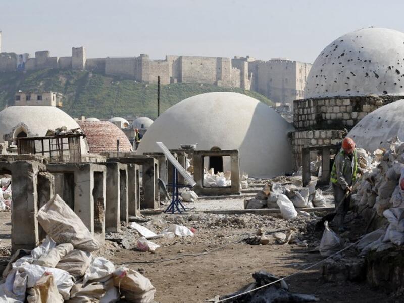 Labourers take part in restoration work at the Saqatiya market in the old quarter of Syria's second city of Aleppo 
LOUAI BESHARA / AFP