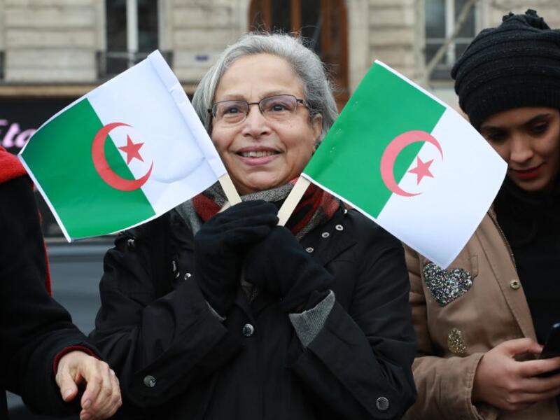 A woman holds Algerian flags during a rally against ailing Algerian president's decision to stand for a fifth term in office
JACQUES DEMARTHON / AFP