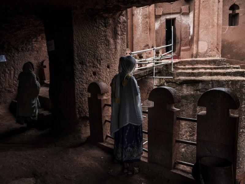 Ethiopian Orthodox devotees stand between the rock-hewn churches of Saint Gabriel and Saint Raphael in Lalibela, Ethiopia
EDUARDO SOTERAS / AFP