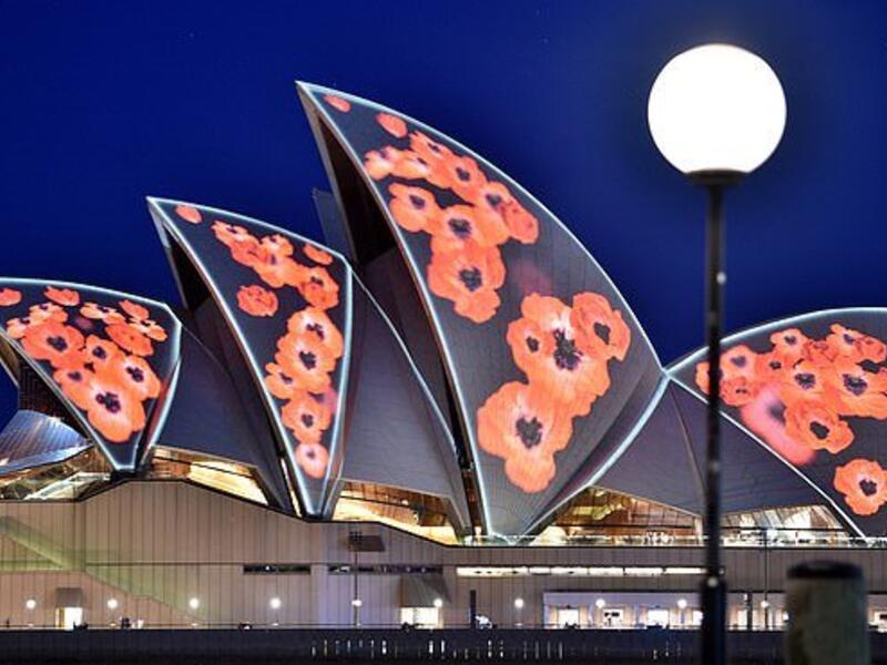The Sydney Opera House is lit up with poppies marking the centenary of the end of World War I (AFP)