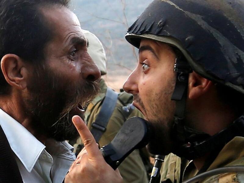 A Palestinian man argues with an Israeli soldier (Twitter)