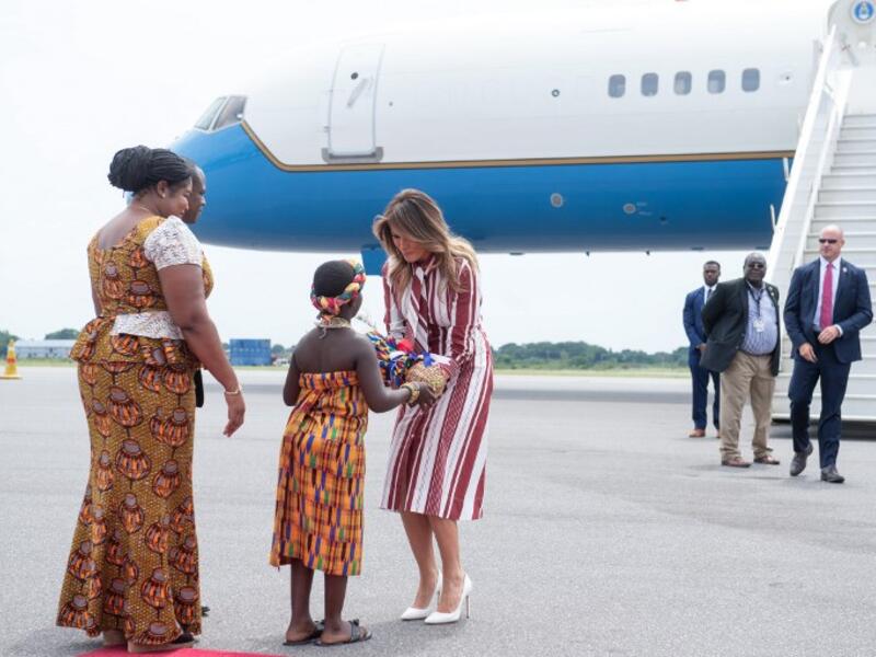 US First Lady Melania Trump receives flowers during an arrival ceremony after landing at Kotoka International Airport in Accra October 2, 2018 as she begins her week long trip to Africa to promote her 'Be Best' campaign.  (SAUL LOEB / AFP)
