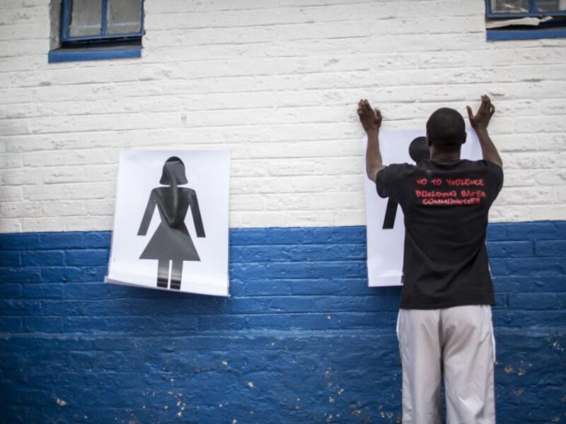 Instructor Den Manda (23) puts up charts on a wall during a session with NGO Action Breaks Silence (ABS). (GULSHAN KHAN / AFP)