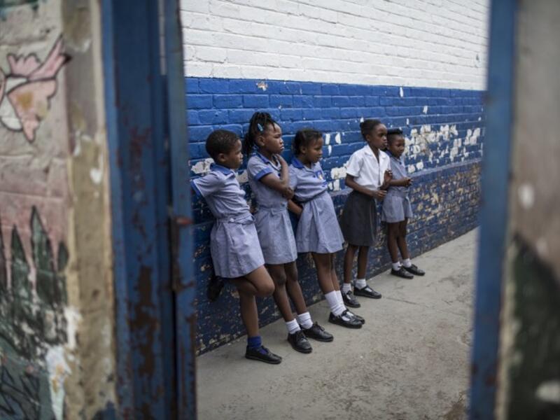 School girls play in a corridor of Mbuyisa Makhubu Primary School in the are of Orlando West, in the South African township of Soweto. (GULSHAN KHAN / AFP)