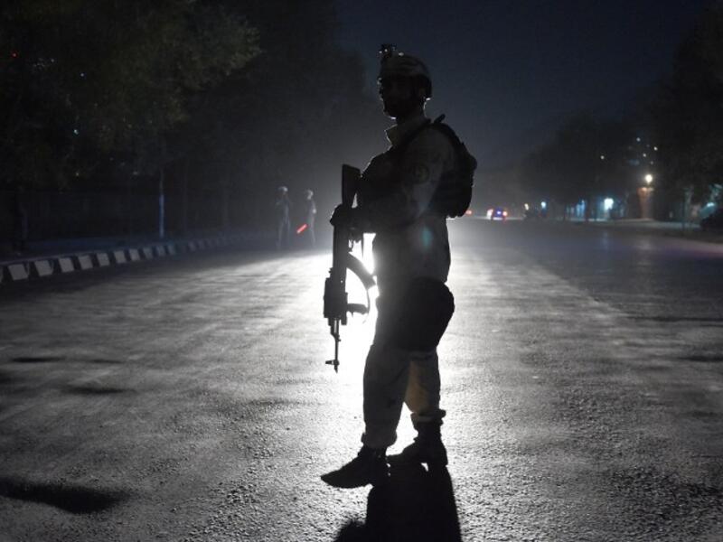 An Afghan security personnel walks as he keep watch near the site of an attack by gunmen inside the Kart-e- Sakhi shrine in Kabul on October 11, 2016. (AFP/Wakil Kohsar)