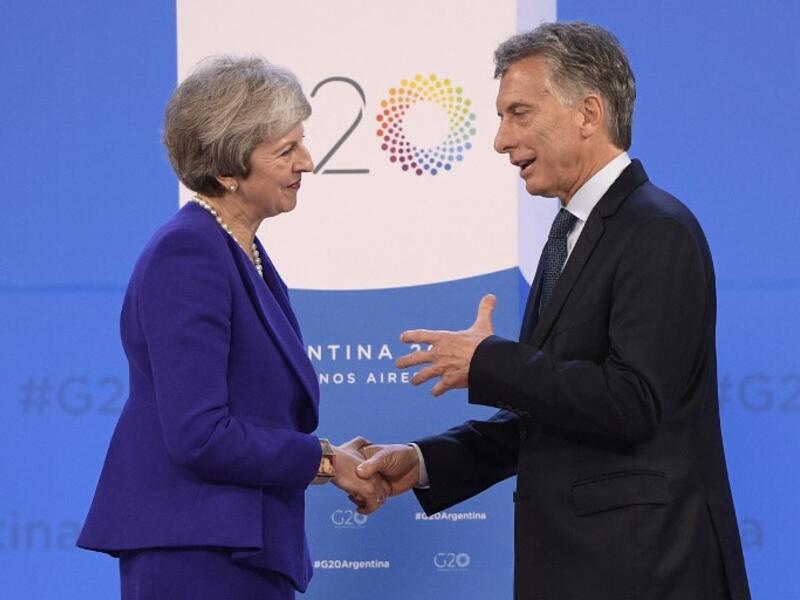 Britain's Prime Minister Theresa May (L) is welcomed by Argentina's President Mauricio Macri at Costa Salguero in Buenos Aires during the G20 Leaders' Summit, on November 30, 2018.
Juan Mabromata / AFP