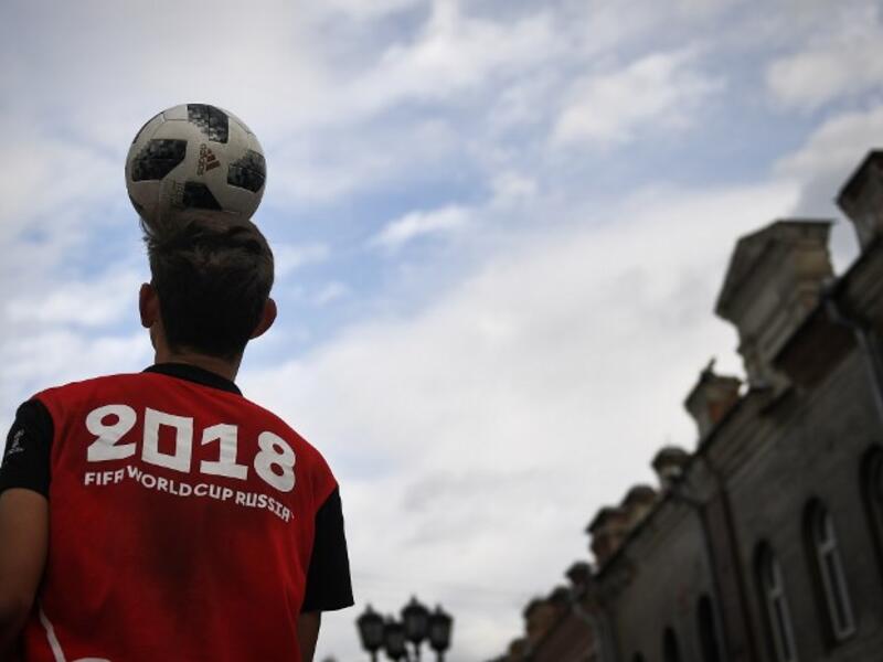 A man juggles a football in the street in Ekaterinburg on June 16, 2018, during the Russia 2018 World Cup football tournament. 
Anne-Christine POUJOULAT / AFP