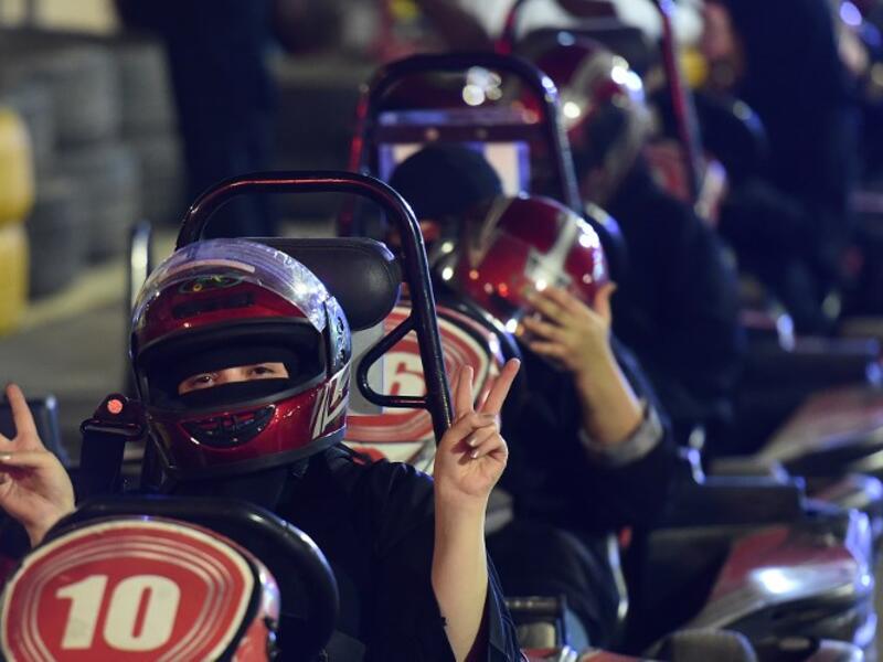 A Saudi woman flashes v-sign as she uses a go-cart during a driving workshop for women in the Saudi capital Riyadh on June 21, 2018.
FAYEZ NURELDINE / AFP