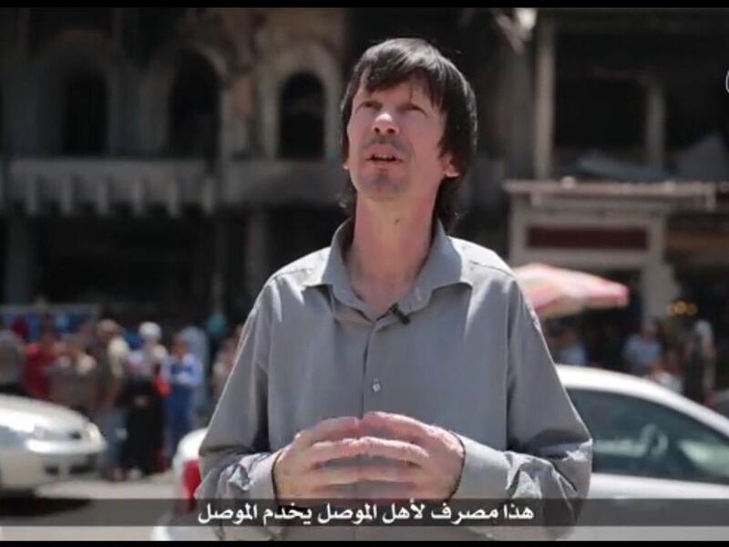 John Cantlie speaks in the latest Isis propaganda video in front of the bombed-out Mosul University. (Twitter) 