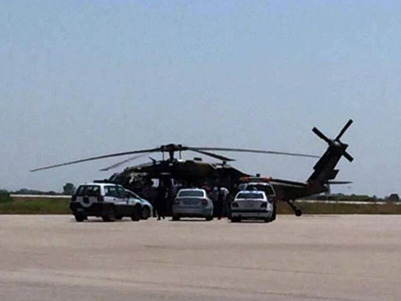 Greek police vehicles next to a Turkish military helicopter at Alexandroupolis airport, after it landed there carrying eight officers seeking asylum after a coup bid in Turkey, on July 16, 2016 (AFP/File) 