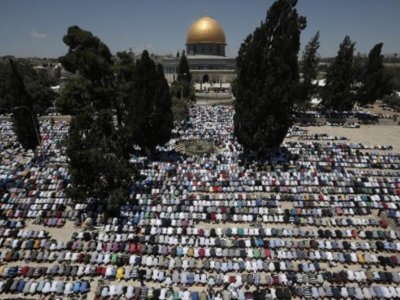 Palestinian Muslim worshipers pray outside the Dome of the Rock at the al-Aqsa compound in Jerusalem during the first Friday prayer of the holy month of Ramadan. (AFP/File)