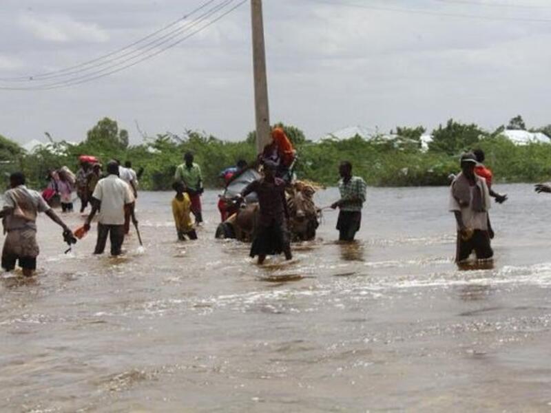 Residents in Beledweyne, Somalia, walk through the flood waters. (Twitter)