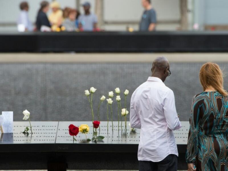 People look over the north memorial pool during the 15th anniversary of September 11 at the 9/11 Memorial and Museum, on September 11, 2016 in New York. (AFP/Bryan R. Smith)