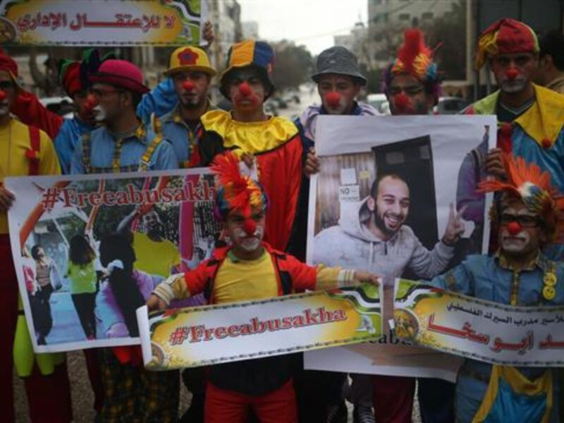 Palestinian circus artists hold portraits of their colleague, Mohammed Abu Sakha, as they demonstrate in Gaza City, Feb. 8, 2016. (AFP/File)